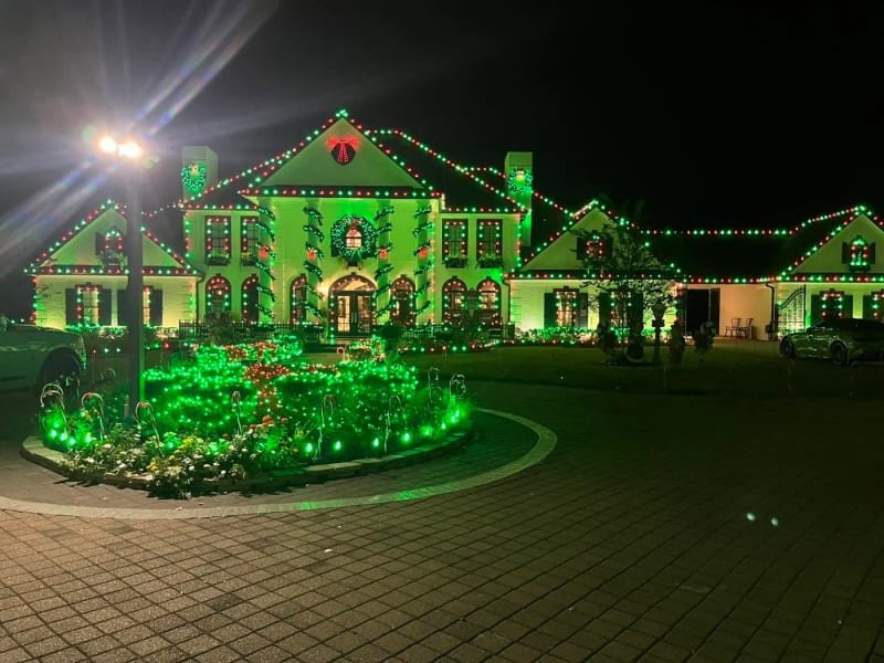 Lit date display outlined in Christmas lights with green accent lighting
