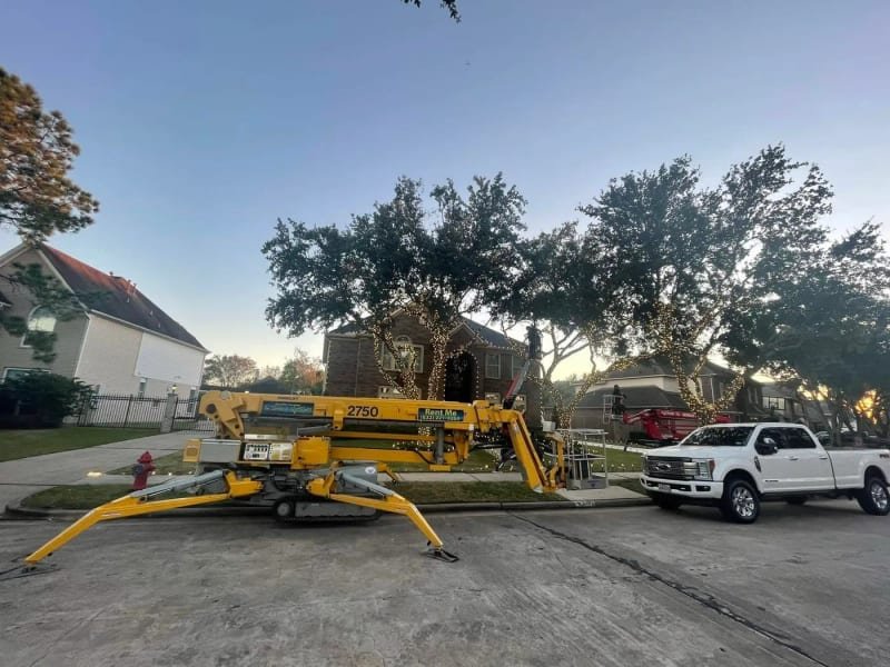 Christmas light installation with man lift boom