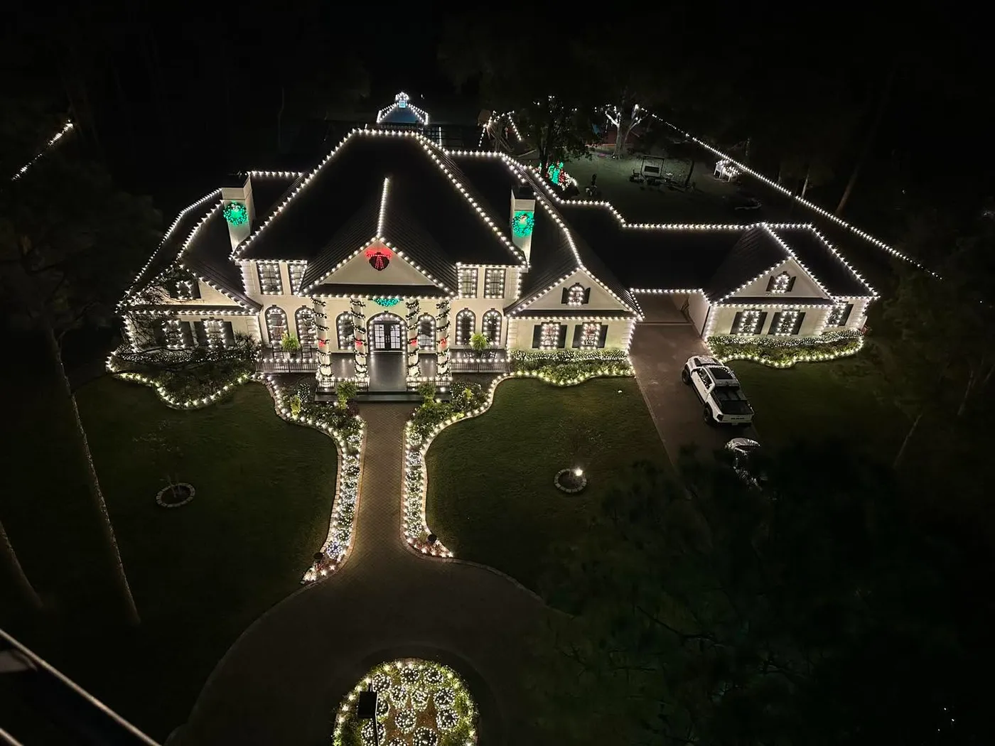A real view of a mansion with lights all over