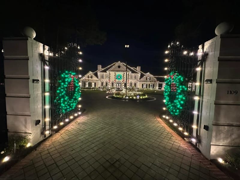 Palatial estate lit for Christmas, seen from the front gate