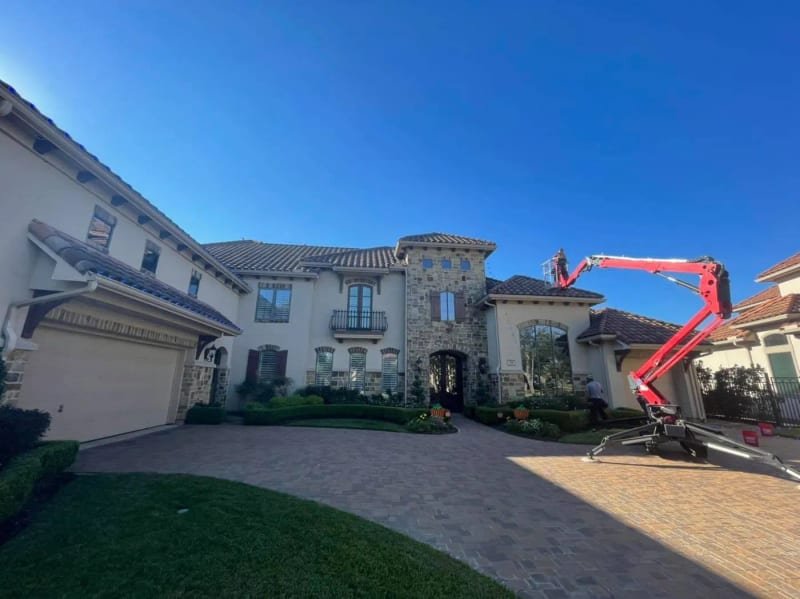 Start of a Christmas light install on a Spanish-style house